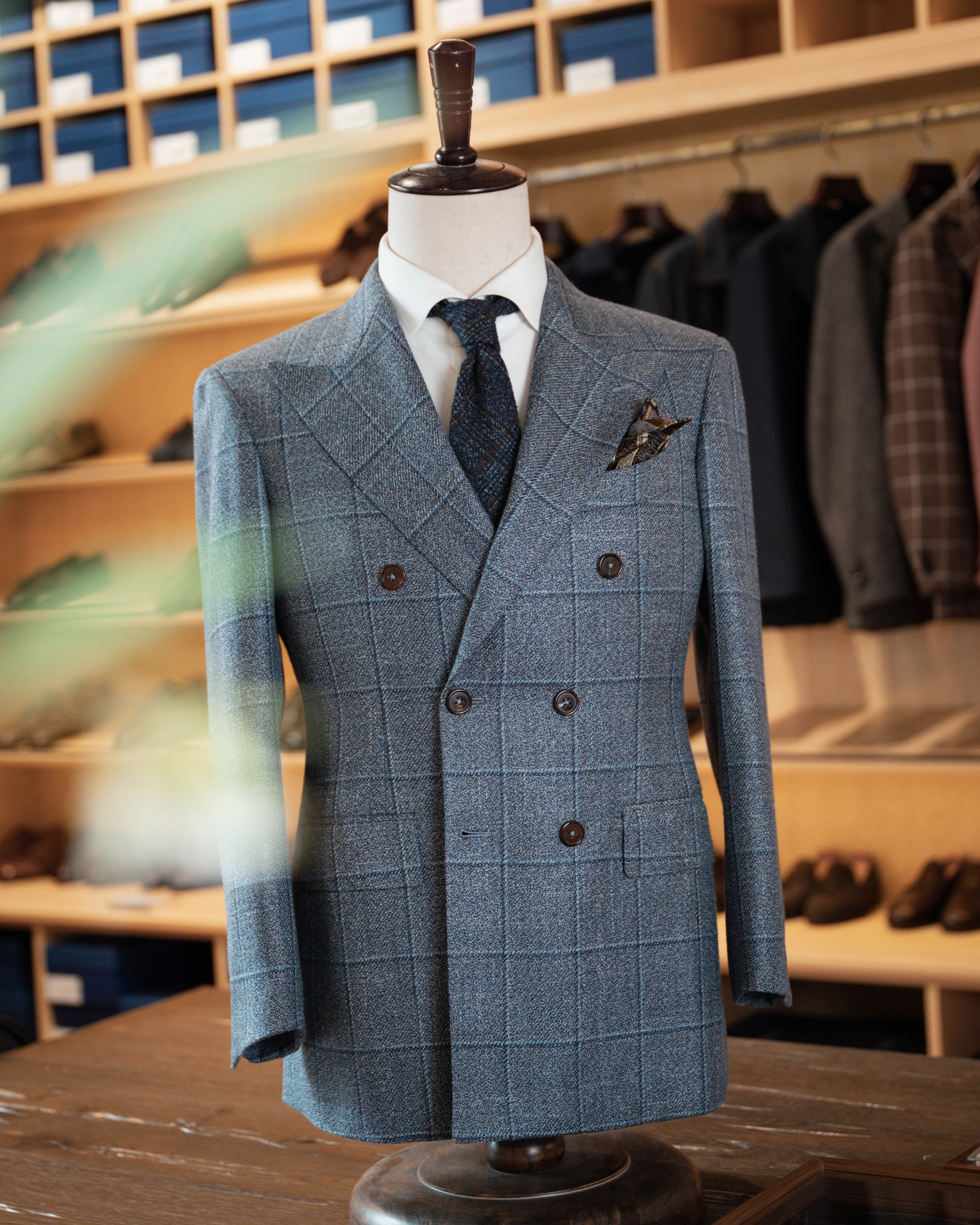 Blue checkered suit on a mannequin in a clothing store setting