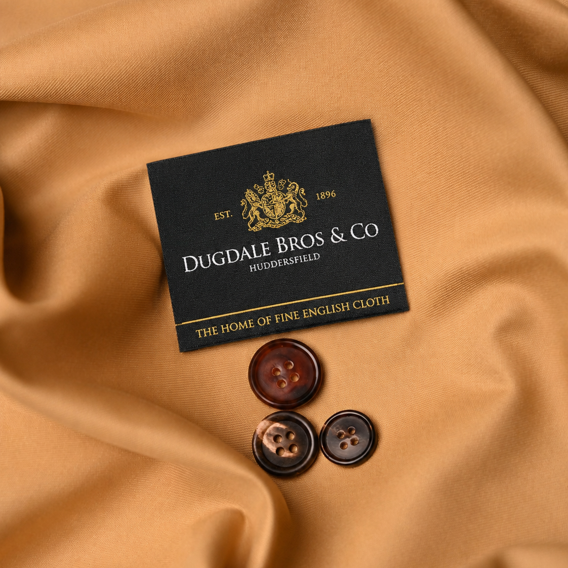 Dugdale Bros & Co box with buttons on a mustard fabric background